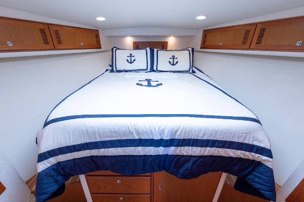 Slide: The Image of Luxurious cabin interior of 2005 Cabo 40 Express yacht with nautical-themed bedding. - 29
