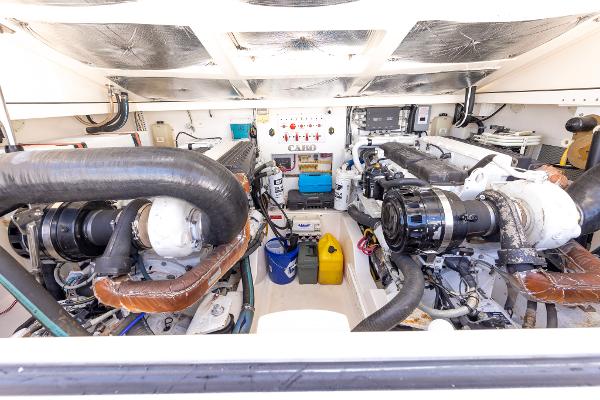 Slide: The Image of Engine room of 2005 Cabo 40 Express boat, showcasing dual engines and equipment. - 33