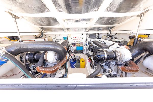 Slide: The Image of Engine room of a 2005 Cabo 40 Express boat, showcasing dual engines and equipment. - 34