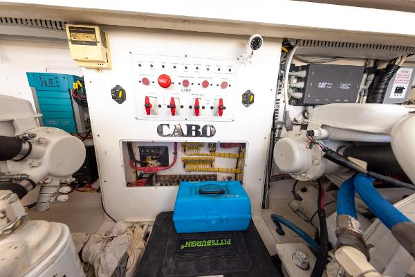 Slide: The Image of Engine room of a 2005 Cabo 40 Express boat, featuring control panels and equipment. - 38
