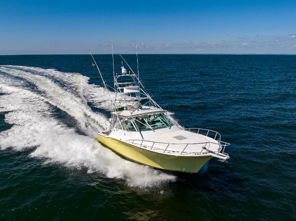 Slide: The Image of 2005 Cabo 40 Express yacht cruising on open sea, leaving a wake behind. - 41