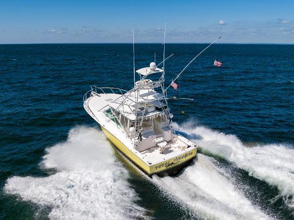 Slide: The Image of 2005 Cabo 40 Express yacht cruising on open ocean waters. - 44