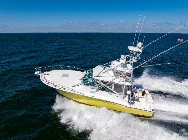 Slide: The Image of 2005 Cabo 40 Express yacht cruising on open sea, showcasing sleek design and performance. - 45