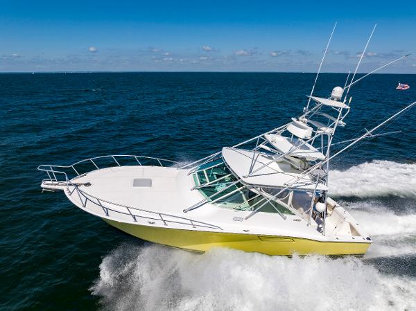 Slide: The Image of 2005 Cabo 40 Express yacht cruising on open sea, showcasing sleek design and performance. - 46