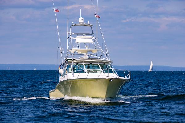 Slide: The Image of 2005 Cabo 40 Express yacht cruising on open water. - 49