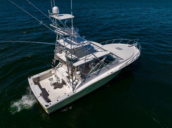 Slide: The Image of 2005 Cabo 40 Express yacht cruising on open water, aerial view. - 9