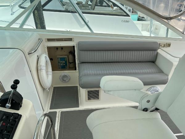 Slide: The Image of 1998 Cabo 45 Express boat interior with gray seating and control panel. - 10