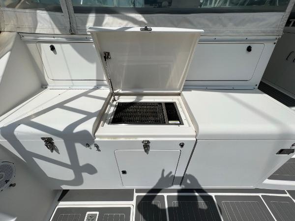 Slide: The Image of 1998 Cabo 45 Express boat with open storage compartment on deck. - 12