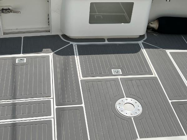 Slide: The Image of 1998 Cabo 45 Express boat deck with gray non-slip flooring. - 16