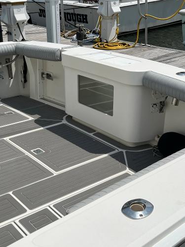 Slide: The Image of 1998 Cabo 45 Express boat deck with seating and storage compartments. - 17