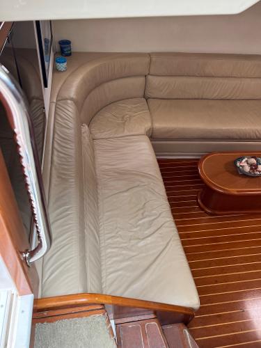Slide: The Image of 1998 Cabo 45 Express interior with leather seating and wooden flooring. - 18