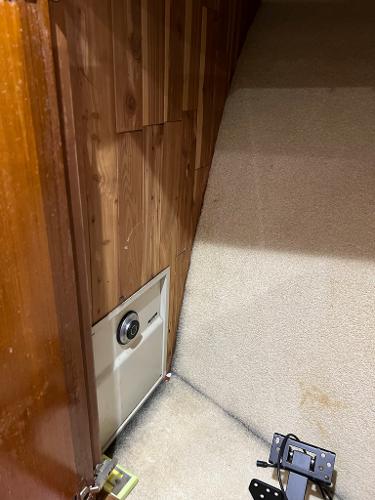 Slide: The Image of Interior of a 1998 Cabo 45 Express boat with wooden paneling and carpeted flooring. - 28