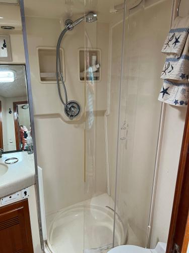 Slide: The Image of 1998 Cabo 45 Express boat bathroom with shower and sink. - 36