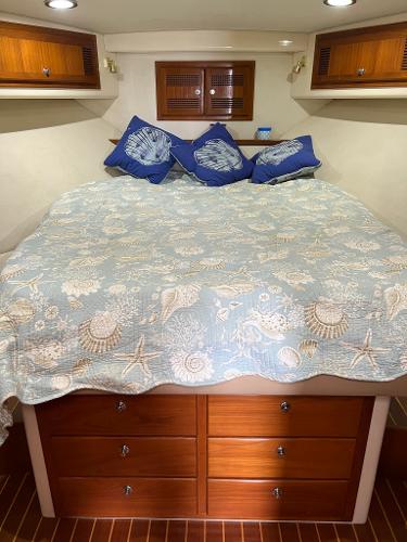 Slide: The Image of 1998 Cabo 45 Express boat cabin with bed and storage drawers - 37
