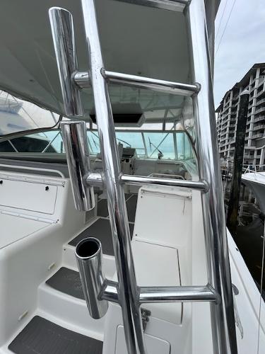 Slide: The Image of 1998 Cabo 45 Express boat interior with stainless steel ladder and rod holders. - 5