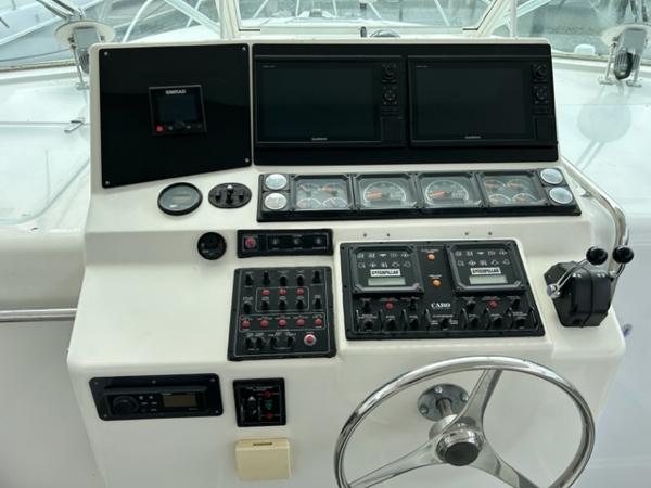 Slide: The Image of 1998 Cabo 45 Express helm with navigation controls and steering wheel. - 6