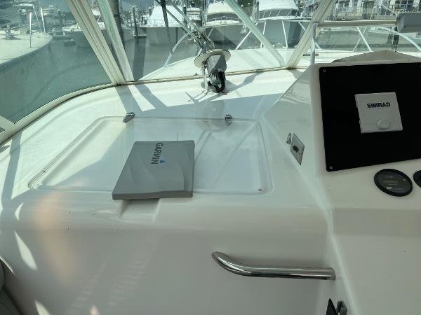 Slide: The Image of 1998 Cabo 45 Express boat dashboard with Garmin and Simrad equipment. - 7
