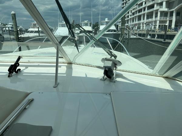Slide: The Image of 1998 Cabo 45 Express yacht docked at marina, view from cockpit. - 8