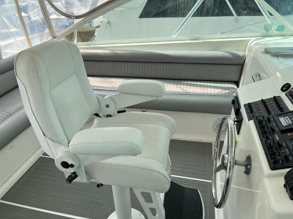 Slide: The Image of Captain's chair and helm of a 1998 Cabo 45 Express boat. - 9