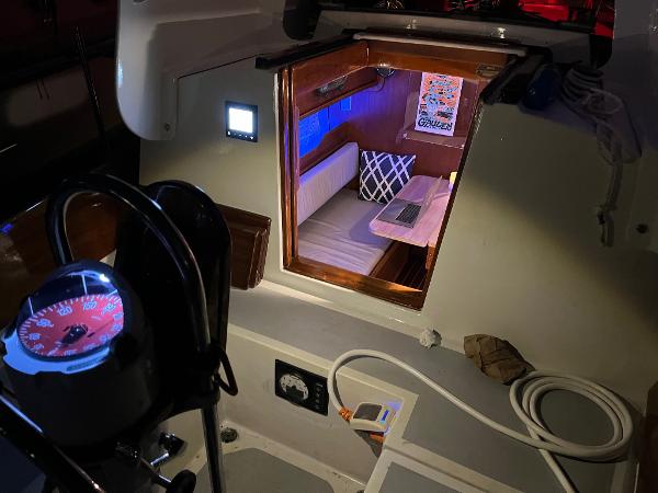 Slide: The Image of Interior view of 1985 Cape Dory 270 sailboat with cozy cabin and navigation equipment. - 46