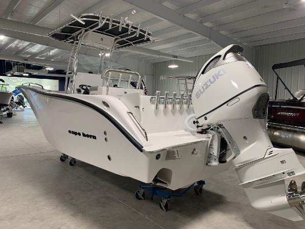 Slide: The Image of 2024 Cape Horn 22 OS boat with Suzuki outboard motor in showroom. - 1
