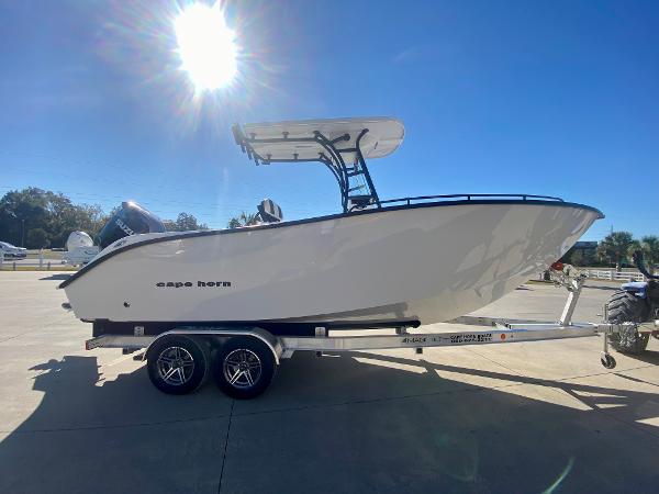Slide: The Image of 2024 Cape Horn 22OS boat on a trailer under a bright sun. - 1