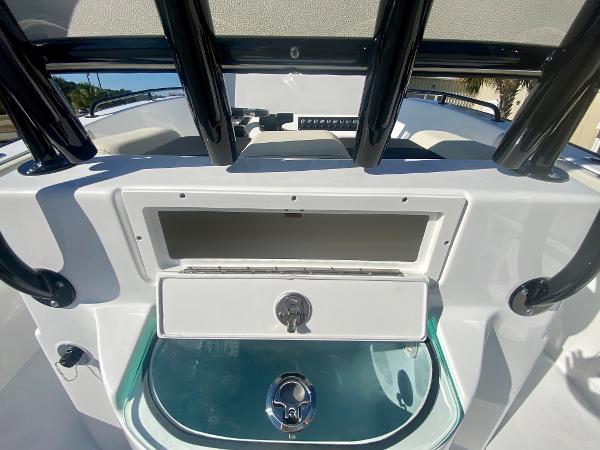 Slide: The Image of 2024 Cape Horn 22OS boat interior with storage compartments and seating. - 12