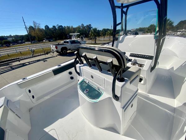 Slide: The Image of 2024 Cape Horn 22OS boat interior with seating and console, parked on a trailer. - 16