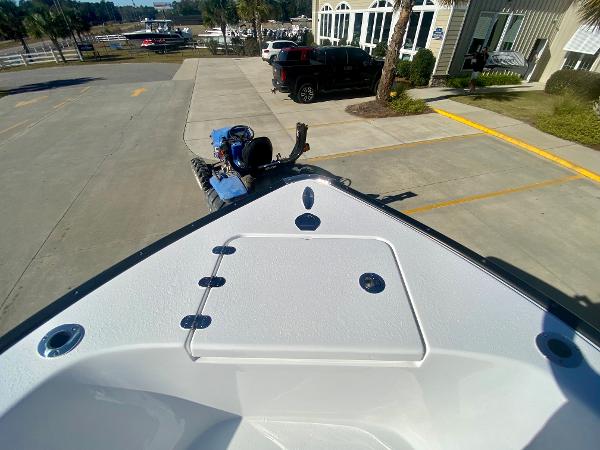Slide: The Image of 2024 Cape Horn 22OS boat bow view at a dealership parking lot. - 23