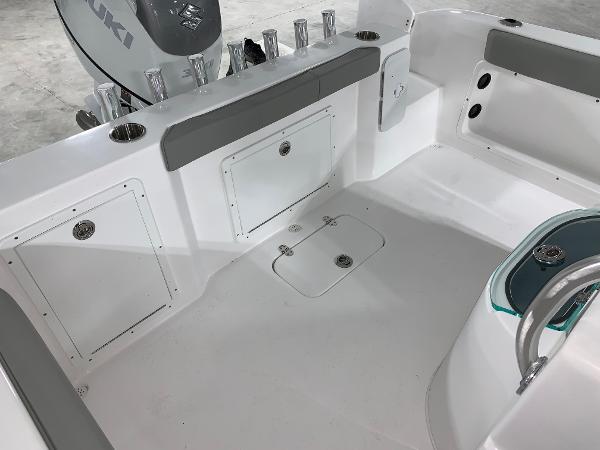 Slide: The Image of 2024 Cape Horn 22 OS boat interior with storage compartments and Suzuki engine. - 5
