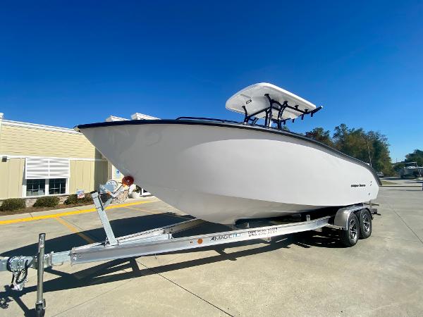 Slide: The Image of 2024 Cape Horn 22OS boat on a trailer in a sunny outdoor setting. - 5