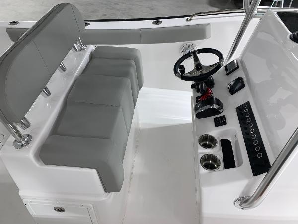 Slide: The Image of 2024 Cape Horn 22 OS boat interior with helm station and seating. - 8
