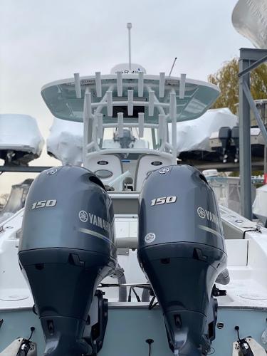 Slide: The Image of 2020 Cape Horn 24 XS boat with dual Yamaha 150 engines, docked and ready for adventure. - 2