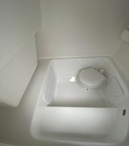 Slide: The Image of 2020 Cape Horn 24 XS boat interior with compact marine toilet. - 24