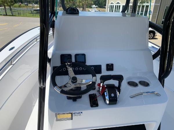 Slide: The Image of 2024 Cape Horn 24 XS boat console with steering wheel and controls. - 11