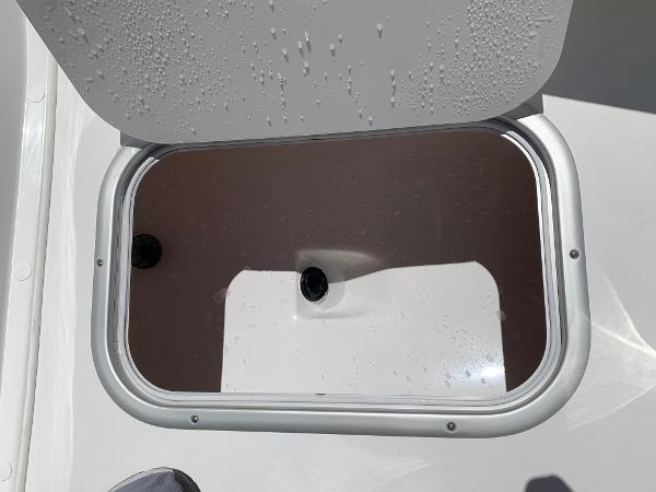 Slide: The Image of Open storage compartment on a 2024 Cape Horn 24 XS boat. - 21