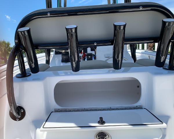 Slide: The Image of 2024 Cape Horn 24 XS boat with rod holders and storage compartment. - 11