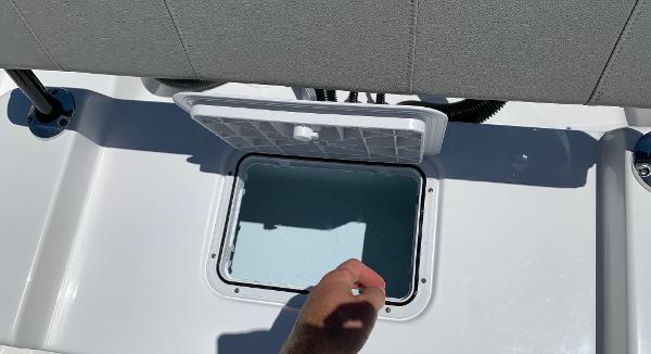 Slide: The Image of 2024 Cape Horn 24 XS boat storage compartment with open lid. - 16