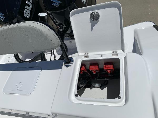 Slide: The Image of 2024 Cape Horn 24 XS boat with open battery compartment and dual Suzuki outboard motors. - 17