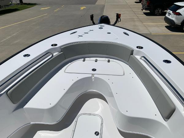 Slide: The Image of 2024 Cape Horn 24 XS boat bow seating area in a parking lot. - 23