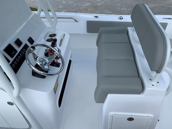 Slide: The Image of 2024 Cape Horn 24 XS boat helm with steering wheel and cushioned seating. - 9