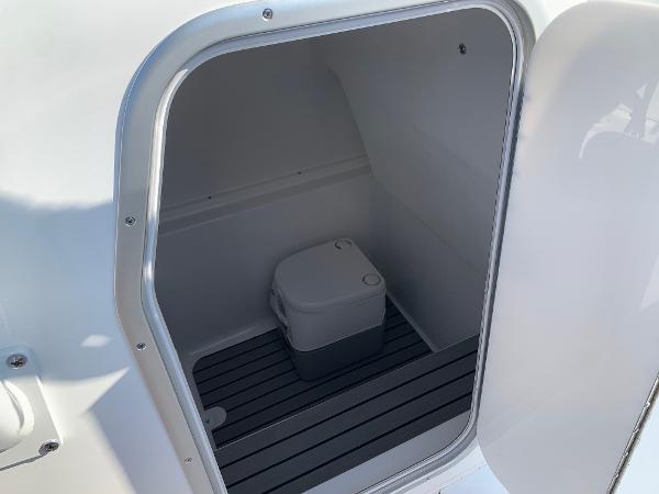 Slide: The Image of 2024 Cape Horn 31T boat interior storage compartment with portable toilet. - 12