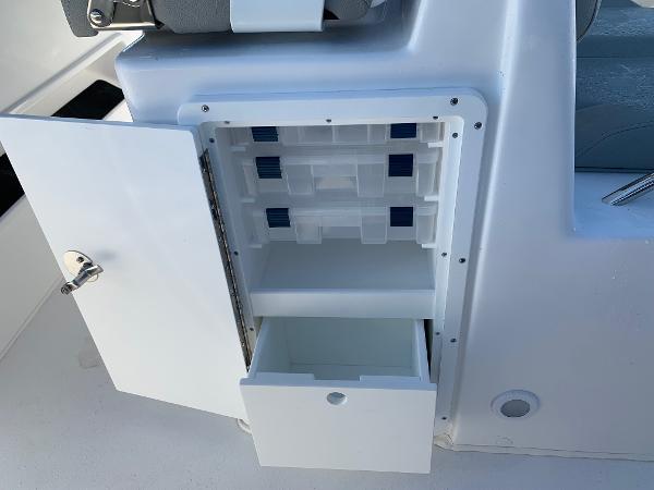 Slide: The Image of 2024 Cape Horn 31T boat storage compartment with open door and drawer. - 8