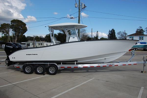 Slide: The Image of 2023 Cape Horn 31T boat on a trailer in a parking lot. - 0