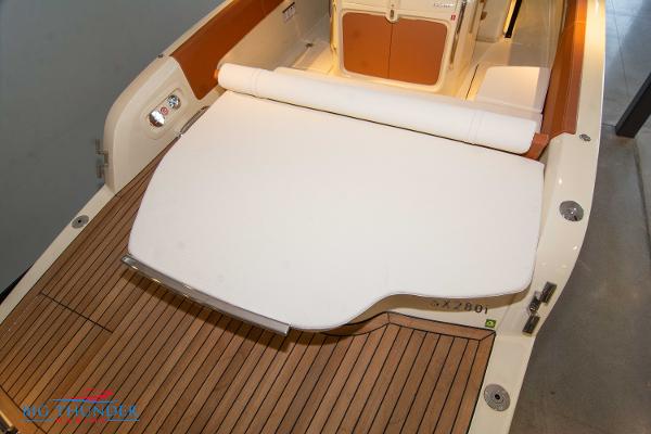 Slide: The Image of Capoforte SX280I 2024 boat with teak deck and cushioned seating area. - 10