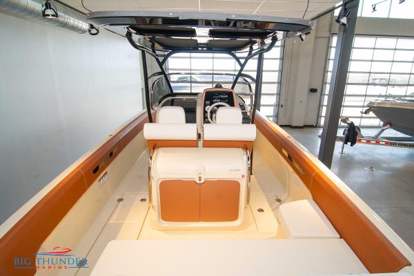 Slide: The Image of 2024 Capoforte SX280I boat interior with seating and console in showroom. - 14