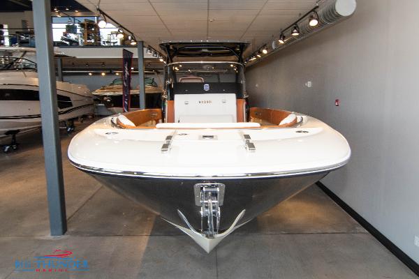 Slide: The Image of 2024 Capoforte SX280I boat displayed in a showroom. - 2