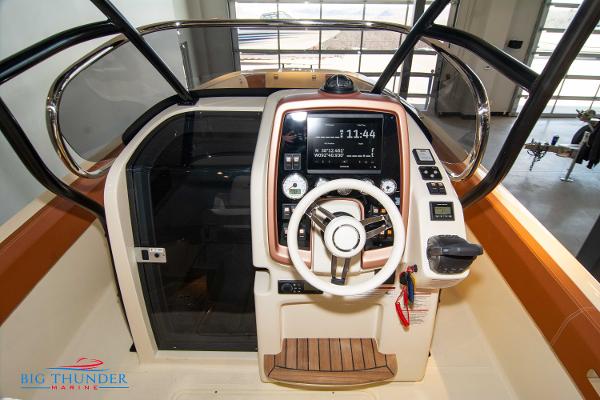 Slide: The Image of 2024 Capoforte SX280I boat dashboard with steering wheel and control panel. - 24