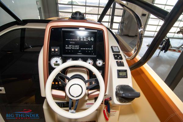Slide: The Image of 2024 Capoforte SX280I boat dashboard with steering wheel, navigation system, and controls. - 28