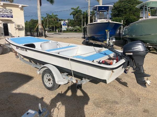 Slide: The Image of 1997 Carolina Skiff 16 DLX boat on trailer with Yamaha outboard motor. - 1